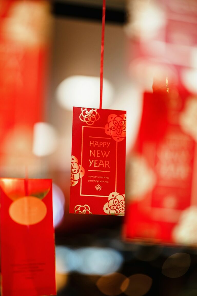 a red packet with a happy new year tag hanging from it